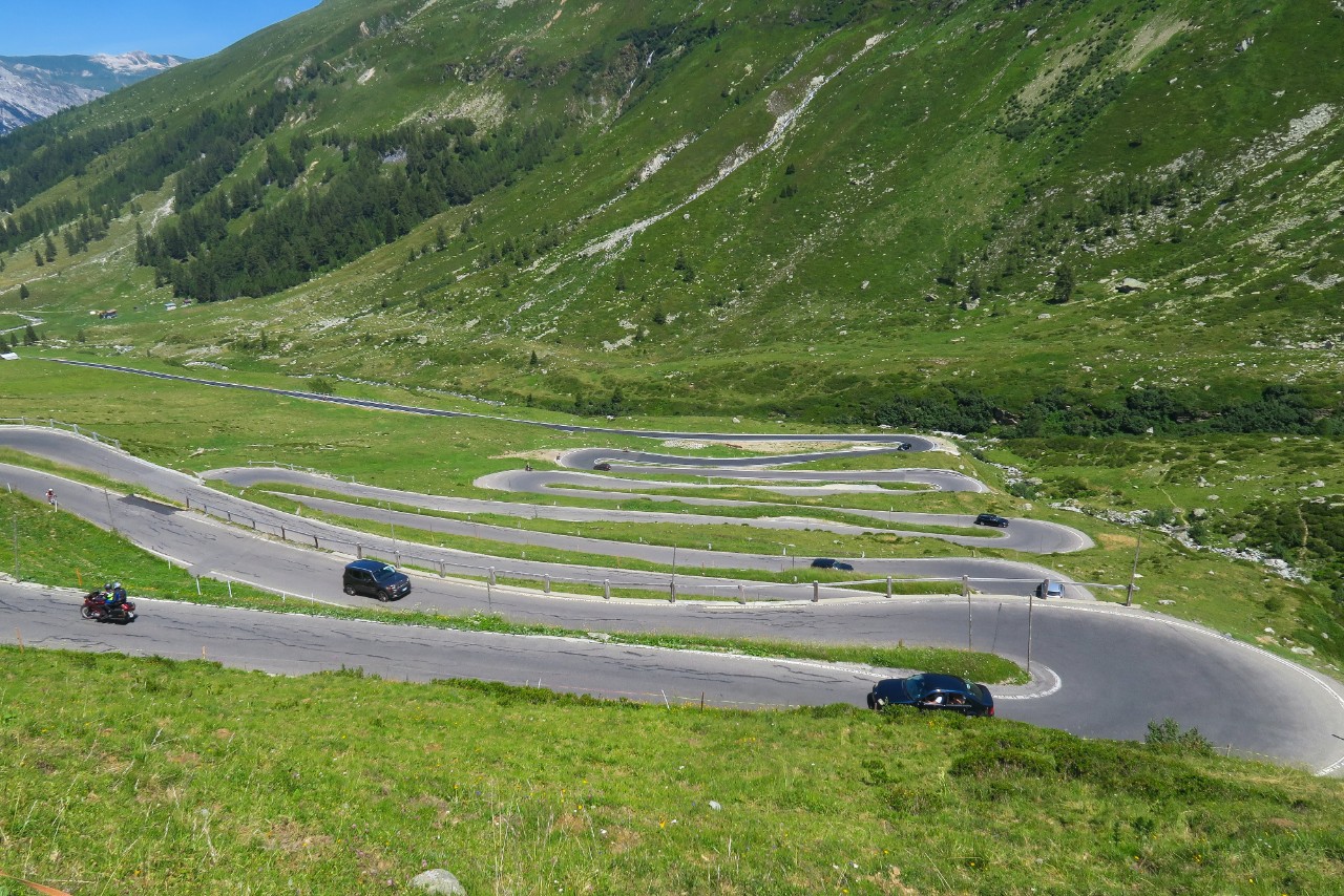 Cars climbing a winding road